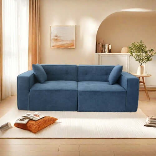 Modern low profile blue memory foam sofa in cozy living room setting with decorative pillows.