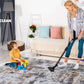 Woman vacuuming multicolor abstract area rug while child plays with blocks, showcasing easy cleaning feature.