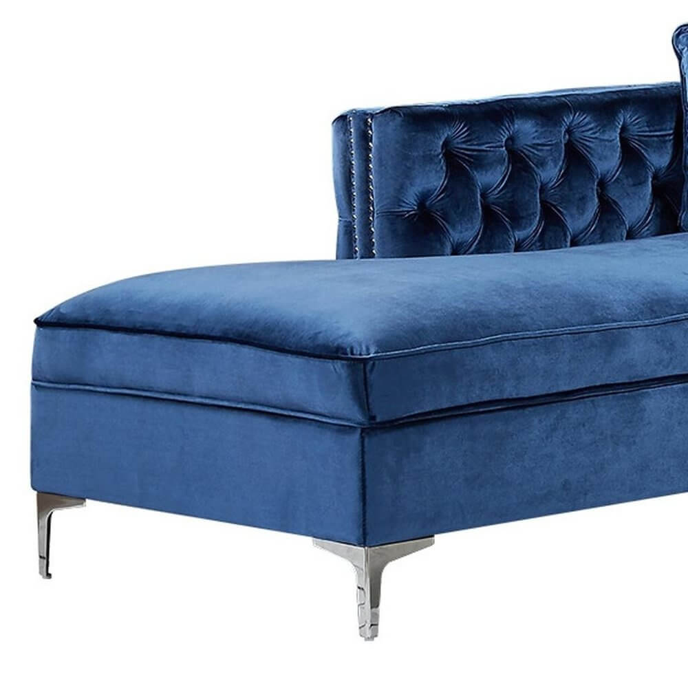 Navy Blue Velvet Rectangular Sofa and Chaise Sectional And Toss Pillows close-up view with tufted back and silver legs.