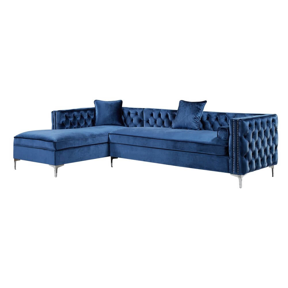 Navy Blue Velvet Rectangular Sofa and Chaise Sectional And Toss Pillows with tufted design and silver metal legs.