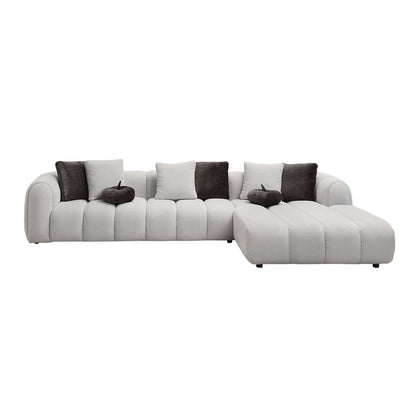 White sectional sofa with 8 pillows offers oversized modern chaise comfort and elegance in a stylish living room.