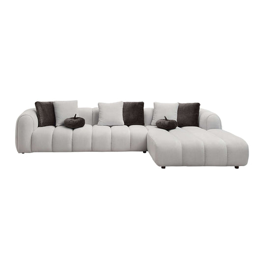 White sectional sofa with 8 pillows offers oversized modern chaise comfort and elegance in a stylish living room.