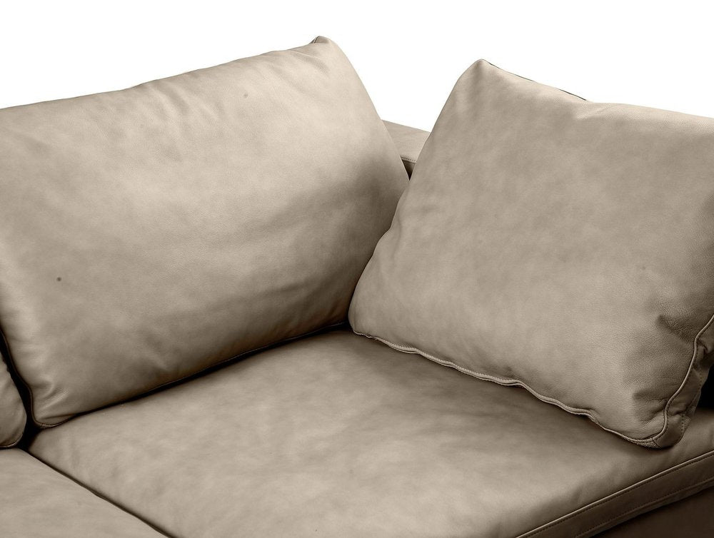Close-up of fabric on 122" Beige Top Grain Leather Reclining Solid Wood Sofa with soft cushions.