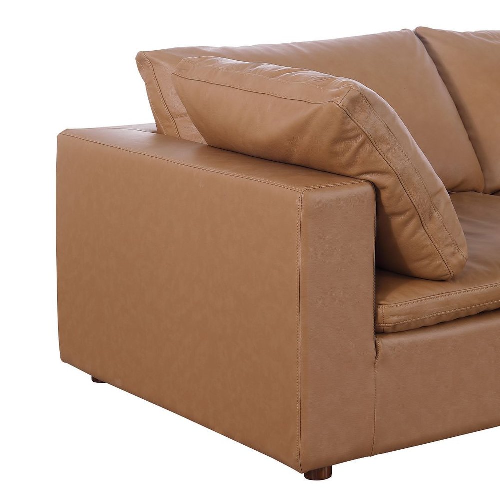 Close-up view of a cushion and armrest of the 122" Beige Top Grain Leather Reclining Solid Wood Sofa.