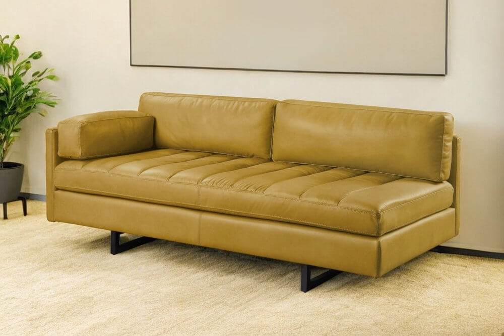 74" Mustard Top Grain Leather Sofa With Black Legs in a modern living room setting, showcasing luxurious comfort and style.