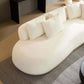 Stylish rounded white L-shaped chaise sofa with plush pillows, perfect for modern living spaces.