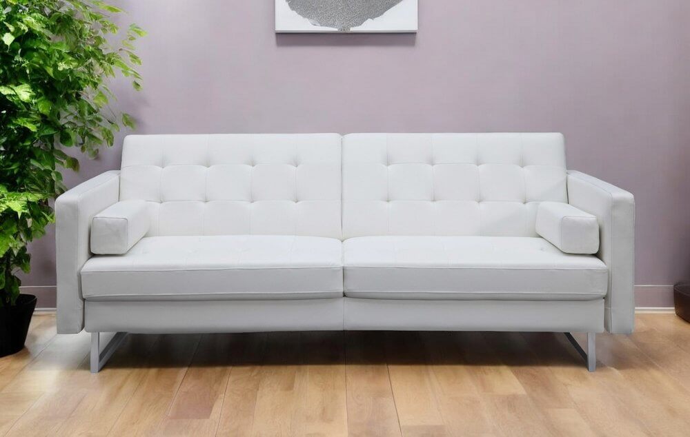 80" White Faux Leather Sleeper Sofa With Silver Legs in stylish living room with green plant.