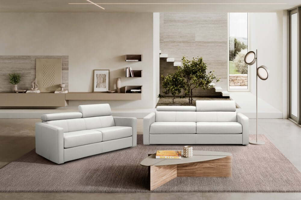 81" White Leather Sleeper Sofa in a modern living room with stylish decor and elegant furniture.