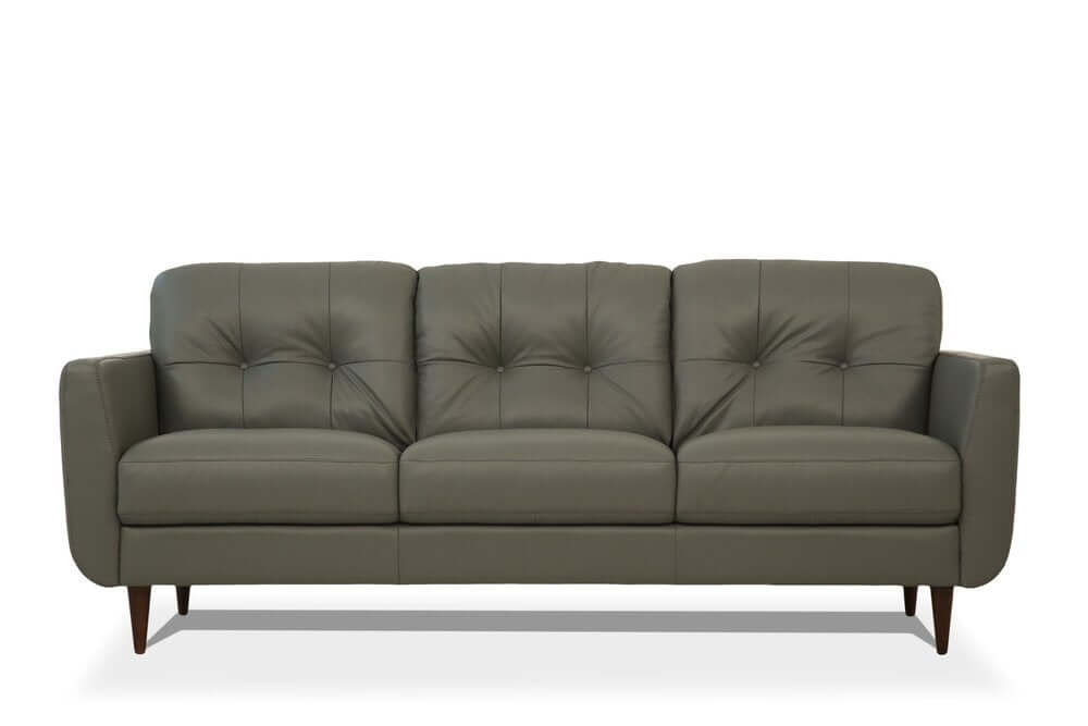 83" Green Leather Sofa With Black Legs featuring plush tufted seating and elegant design.
