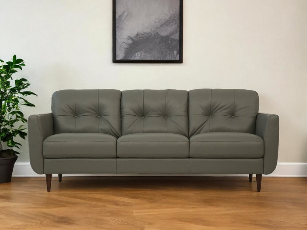 83" Green Leather Sofa With Black Legs in a stylish living room setting.
