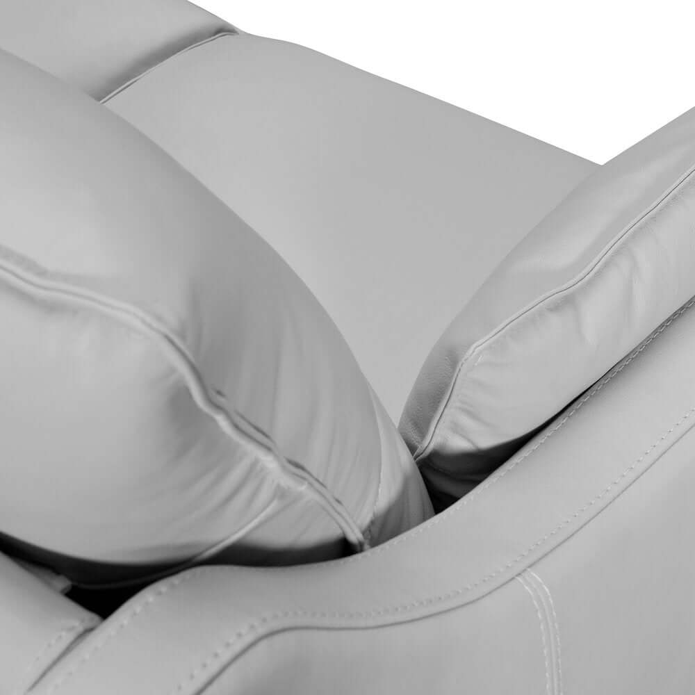 Close-up of the 87" Gray Leather Sofa And Toss Pillows With Brown Legs showcasing plush leather and soft cushions.