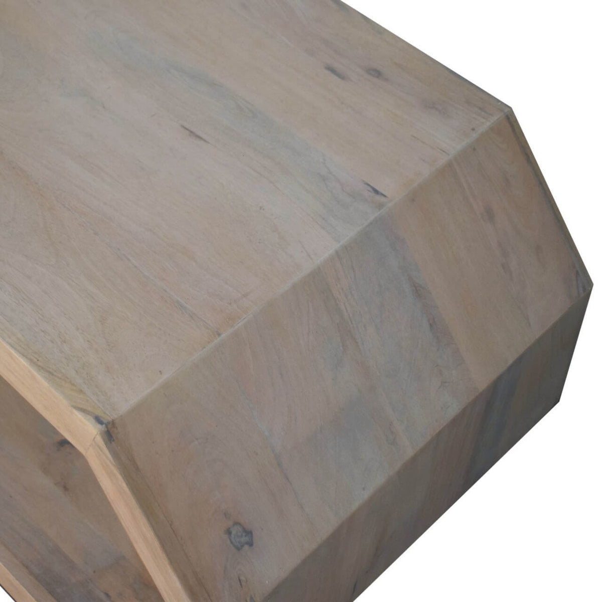Close-up of solid wood surface of hexagonal coffee table showcasing natural grain and unique shape.