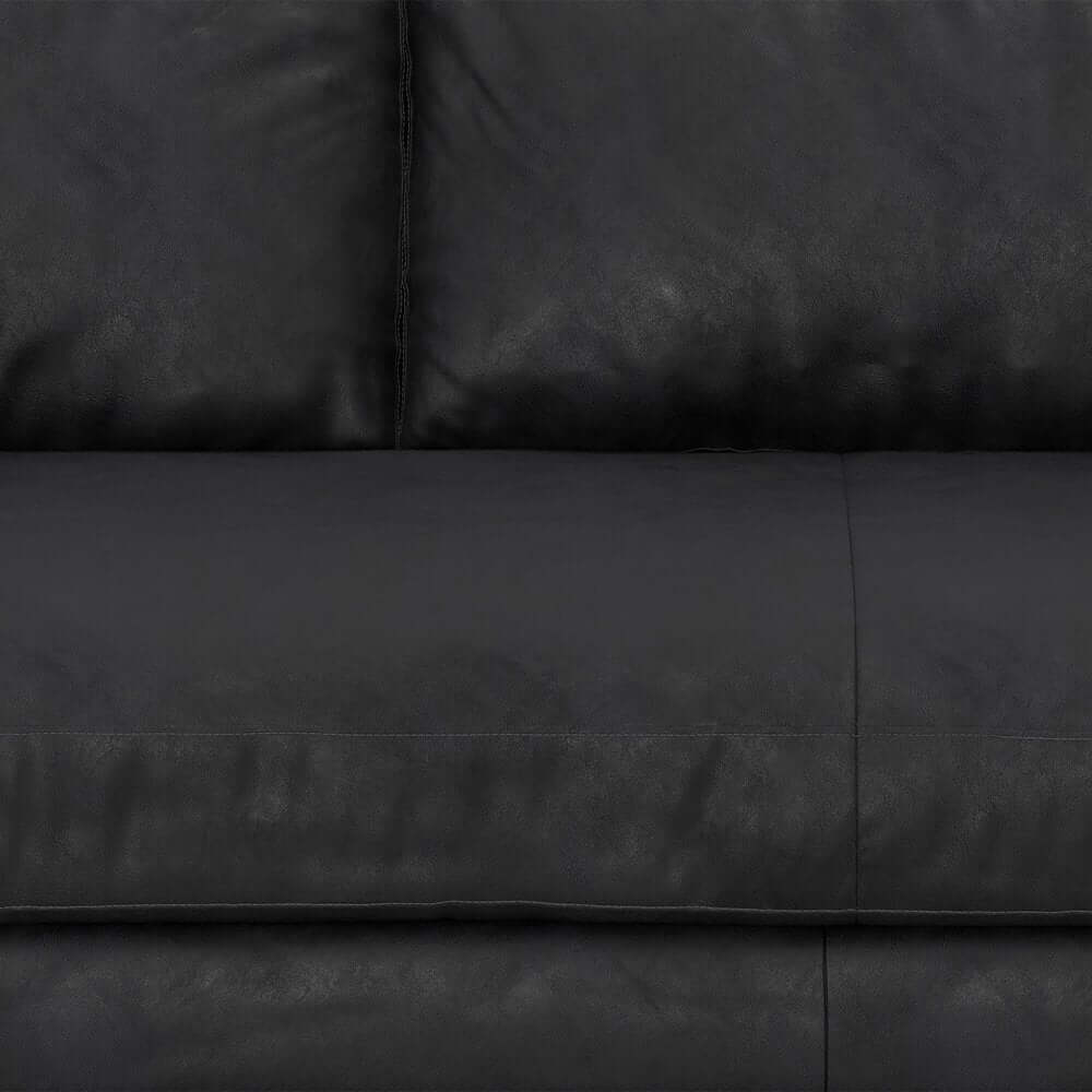 89" Black Leather Sofa With Brown Legs close-up view of soft black leather upholstery.