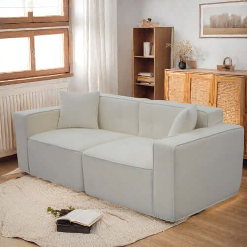 Modern low profile box arm memory foam sofa in light color, blending comfort and contemporary style for any living room.