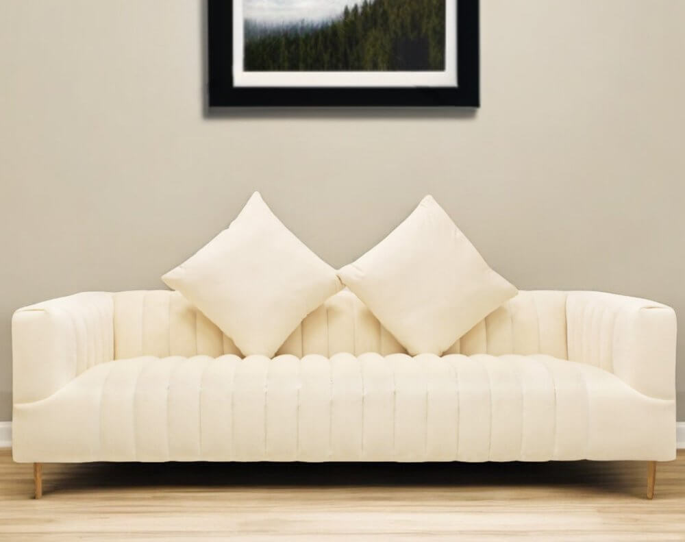 90" Ivory Velvet Sofa And Toss Pillows With Gold Legs in a cozy living room setting.