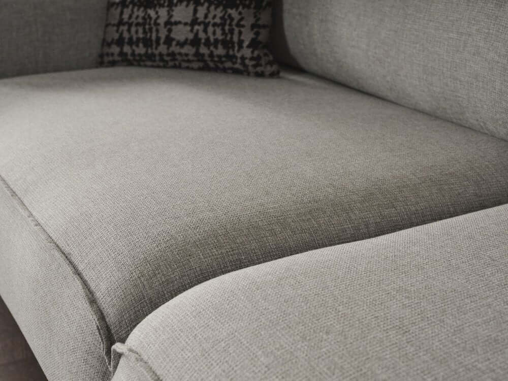 Detail of the 90" Linen Linen Sleeper Sofa and Toss Pillows with Silver Legs showcasing soft grey fabric.