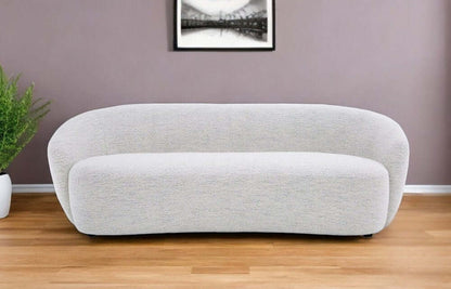90" Off White Fabric Sofa With Black Legs in a contemporary living room setting.