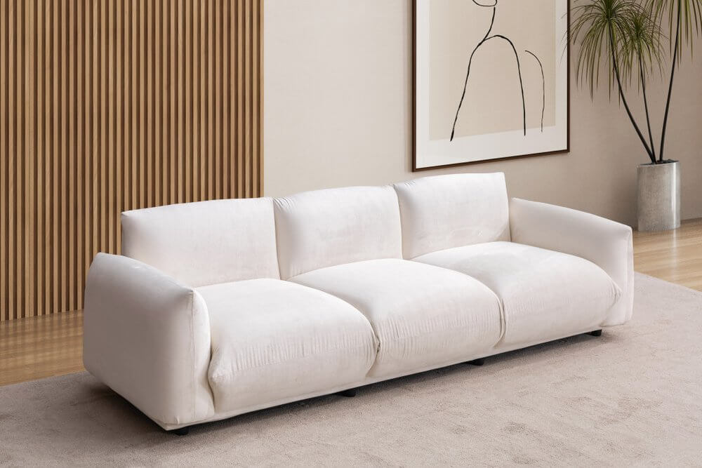 98" White Velvet Sofa in a modern living room setting with a minimalist design and decorative elements.