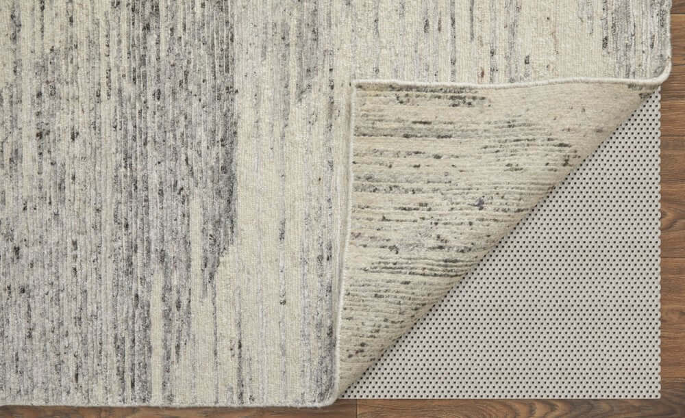 9' X 13' Ivory and Gray Abstract Hand Knotted Worn Faded Area Rug showcasing its texture and backing.