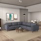 A modern living room showcases the Ashcroft Furniture Amber MCM Corner Sectional Sofa 103 in gray on a beige rug, paired with a round wooden coffee table, wall art, floor lamp, and a dining area with a white table and chairs in the background.