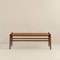 The Ashcroft Furniture Cody MCM Strapped Genuine Leather Bench 44 features a tan leather woven seat and minimalist mid-century modern wooden design, shown against a plain light-colored wall and floor.