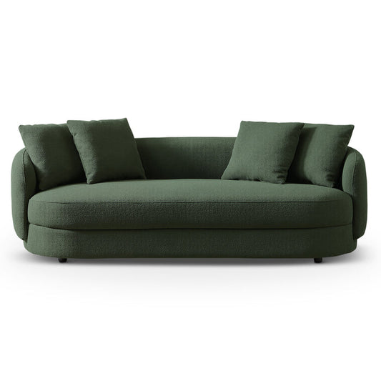 The Dylan Modern Bohemian French Boucle Sofa 85 by Ashcroft Furniture Co features dark green upholstery, rounded edges, and three matching cushions, offering Parisian elegance against a plain white background.