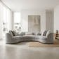 Ivria Gray Bouclé Sectional Sofa – Curved Modular Sofa with 9 Pillows (Modern Statement) in a bright living room.