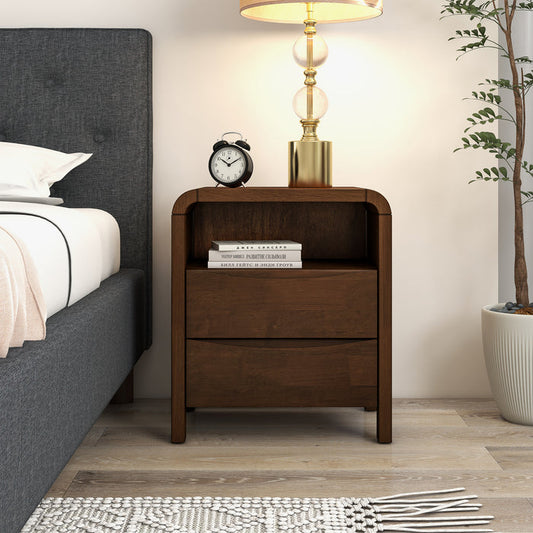 Mid Century Modern Solid Wood Nightstand – 2 Drawer Walnut Bedside Table (23.6” H) with lamp and clock beside a bed.
