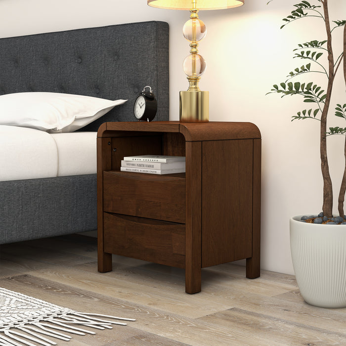 Mid Century Modern Solid Wood Nightstand – 2 Drawer Walnut Bedside Table (23.6” H) beside a bed with lamp and plant.