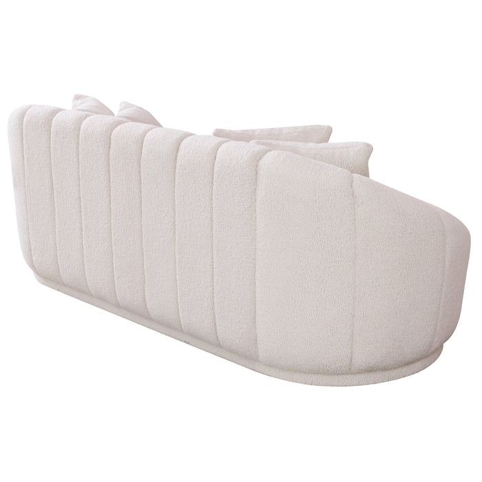 The Ashcroft Furniture Maximilian Japandi Channel Tufted Boucle Sofa 86” features a modern curved back, vertical channel tufting, matching cushions, and white boucle upholstery, blending sustainable luxury with minimalist design.