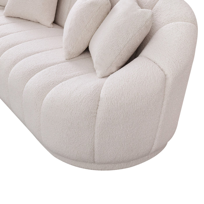 Close-up of the Ashcroft Furniture Maximilian Japandi Channel Tufted Boucle Sofa 86” in cream textured fabric, featuring a modern, rounded design and two matching pillows placed against the backrest.