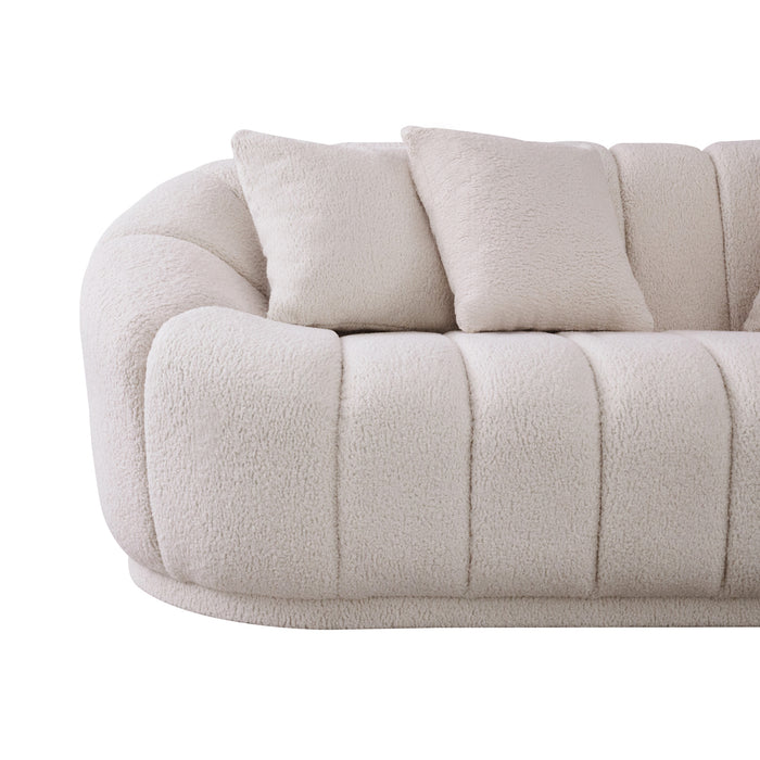 The Ashcroft Furniture Maximilian Japandi Channel Tufted Boucle Sofa 86” features plush cream boucle, a rounded back and armrest, vertical stitching, and two matching square pillows for a touch of sustainable luxury.