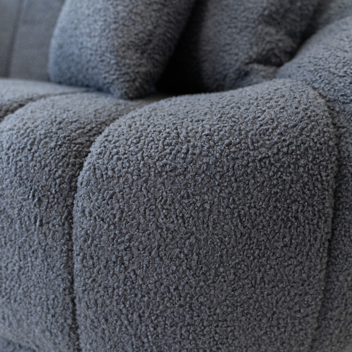 Close-up of the Ashcroft Furniture Maximilian Japandi Channel Tufted Boucle Sofa 86” in gray, highlighting its textured boucle fabric, soft plush padding, stitched seams, and channel tufting.