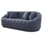 The Ashcroft Furniture Maximilian Japandi Channel Tufted Boucle Sofa 86”, in modern dark gray with a rounded back and three matching cushions, features channel tufted upholstery and is shown against a white background.