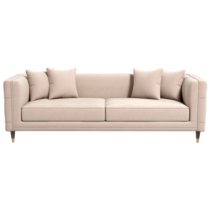 The Ashcroft Furniture Edward MCM Elegant Tufted Velvet Sofa 90 features square arms, wooden legs, four matching throw pillows, and subtle mid-century design elements, shown in beige against a white background.