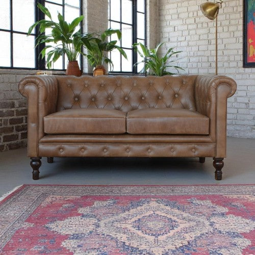 Buffalo Leather Chesterfield Loveseat 59" – Tufted Brown Leather Sofa with Rolled Arms in a stylish living room.