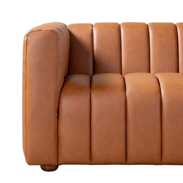 Elrosa Channel Tufted Cognac Faux Leather Sofa side view highlighting tufting and warm cognac color.