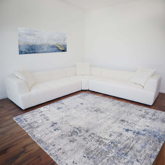 Ivory bouclé L-shape sectional sofa in modern living room with abstract wall art and a patterned rug.