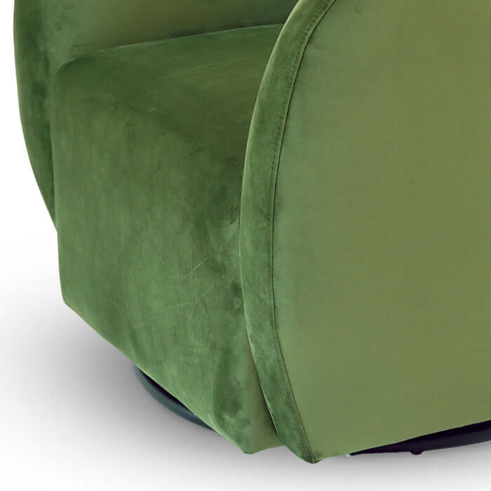 Close-up view of the Renee Swivel Lounge Chair showcasing its green velvet upholstery and stylish barrel design.