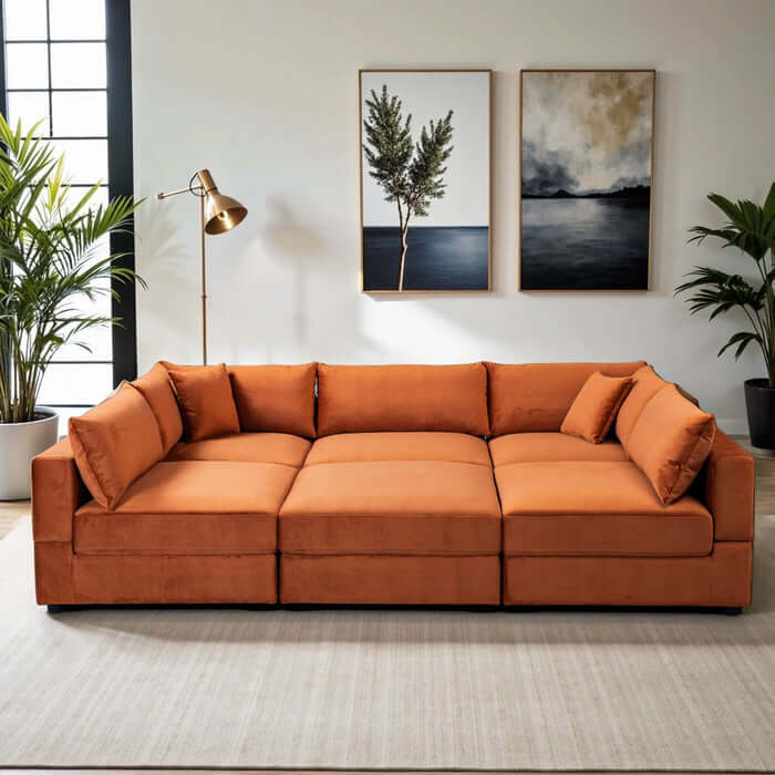 Uptown Burnt Orange Velvet Modular Sofa Sectional in modern living room with art and plants.