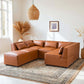 Wexford Cognac PU Leather 5 Pc Modular Sectional Sofa in a stylish living room setting with decorative elements.