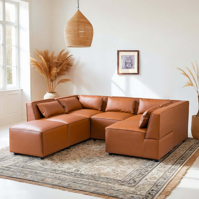 Wexford Cognac PU Leather 5 Pc Modular Sectional Sofa in a stylish living room setting with decorative elements.