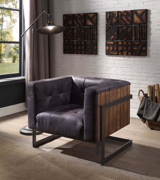 Antique Ebony Tufted Leather Accent Chair – Rustic Oak & Metal Sled Base in modern interior setting with lamp