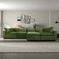 Green Hayward Velvet Modular Sectional Sofa in a modern living space with minimal decor.