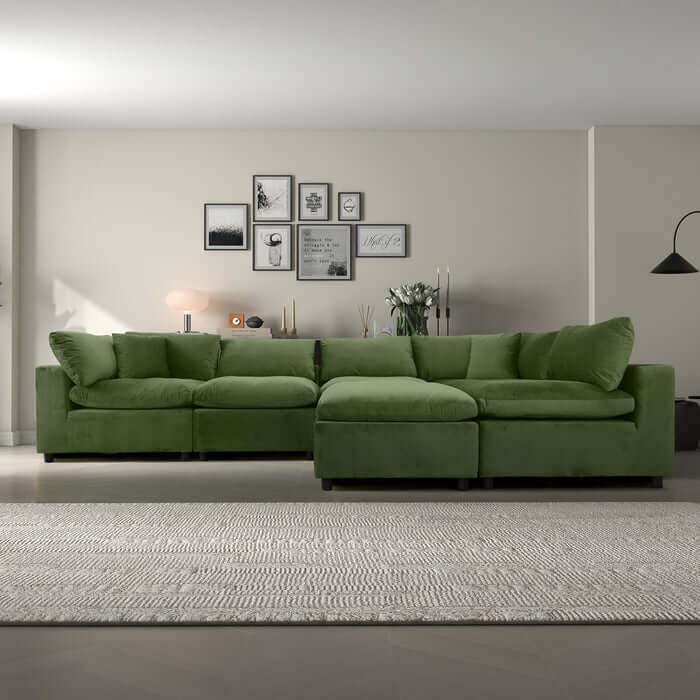 Green Hayward Velvet Modular Sectional Sofa in a modern living space with minimal decor.
