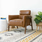 Kayson MCM tan leather lounge chair in modern living room with decor accents and soft area rug.