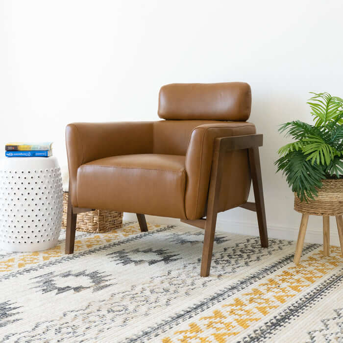 Kayson MCM tan leather lounge chair in modern living room with decor accents and soft area rug.