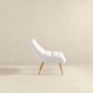 Aubrey Tufted Boucle Lounge Chair – Modern Armless Accent Chair (2 Colors) in white tufted fabric with wood legs.