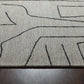 Close-up of Abbey Valetta handwoven wool area rug featuring abstract black lines on a neutral background.