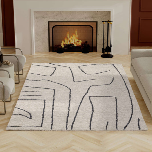 Abbey Valetta handwoven wool area rug with abstract design in modern neutral tones, placed in a stylish living room.